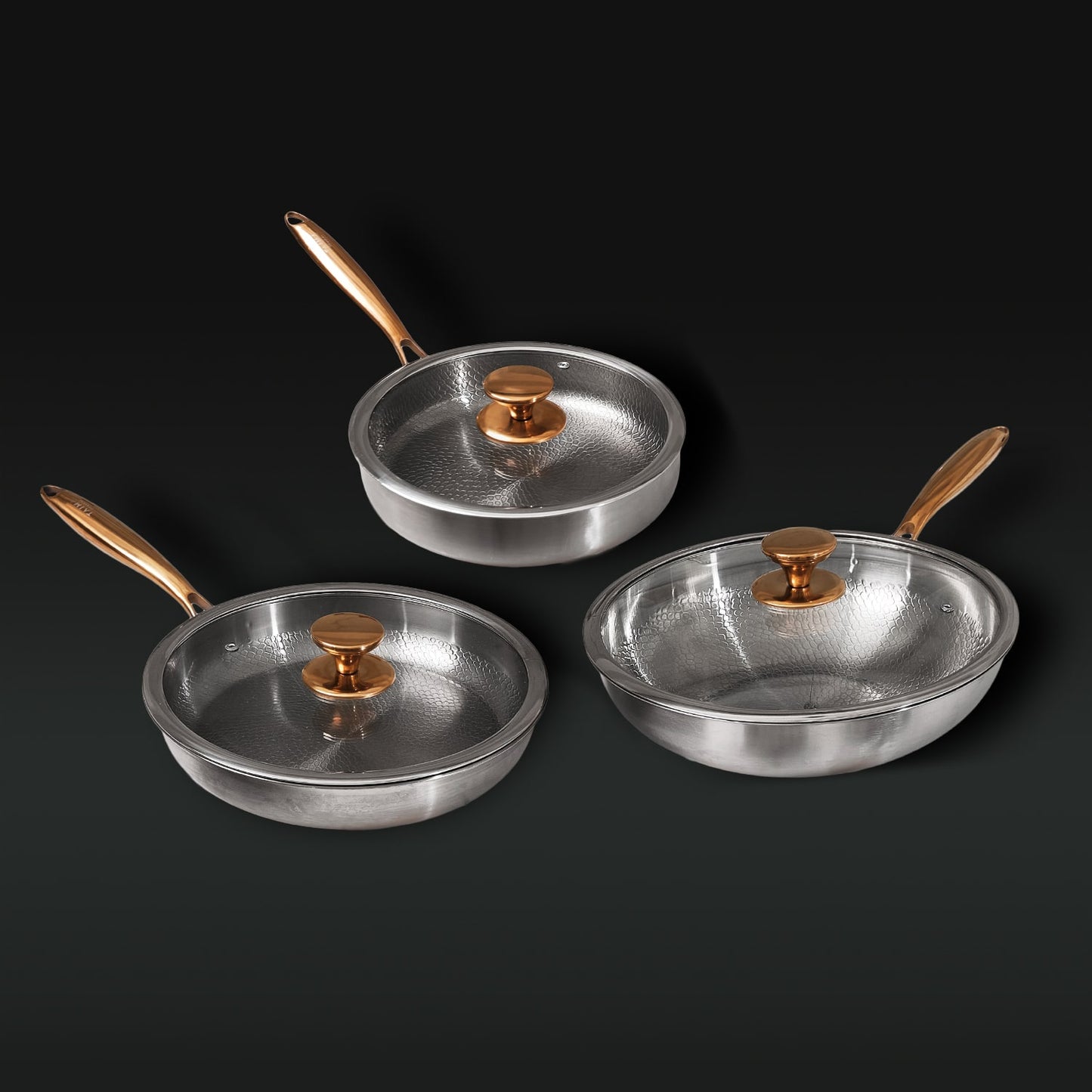 Set of three titanium frying pans with lids