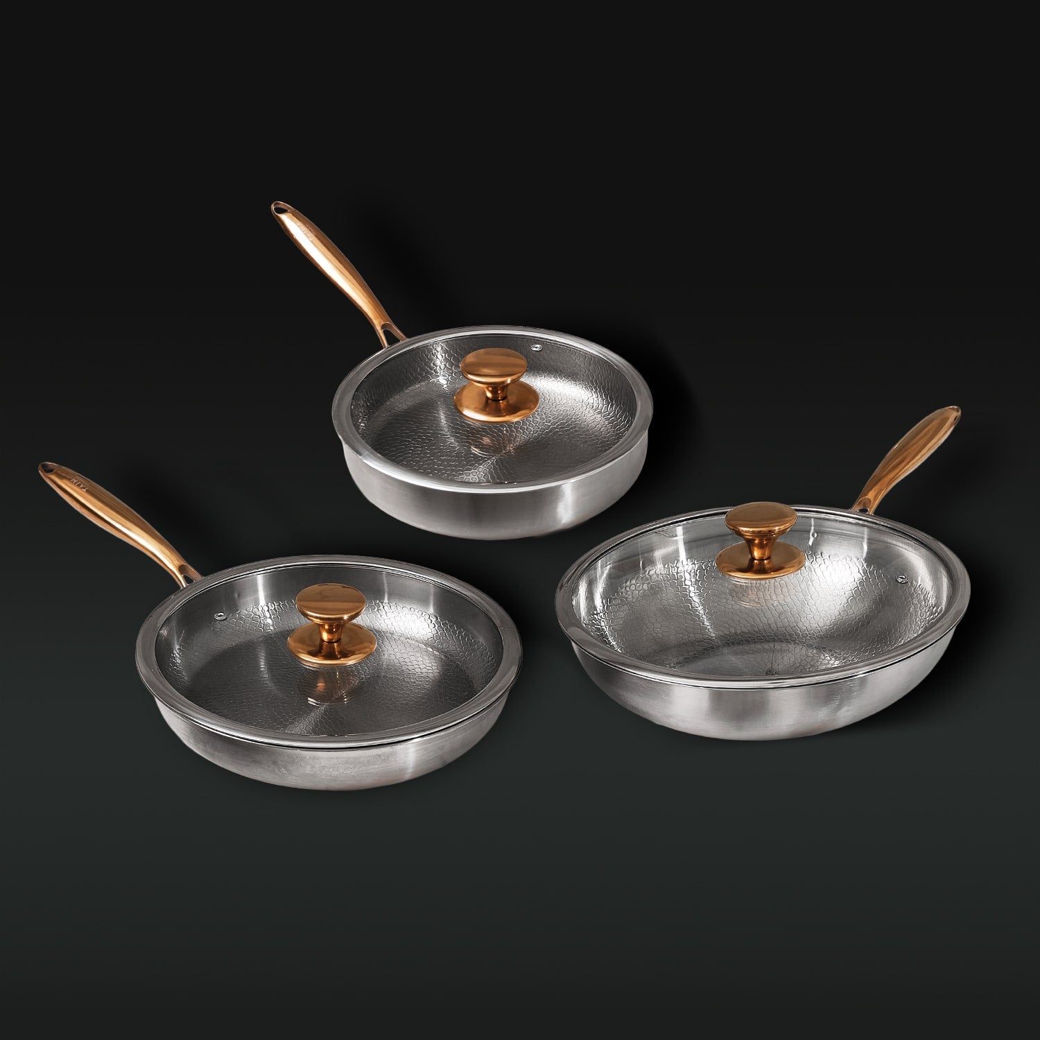 Set of three titanium frying pans with lids