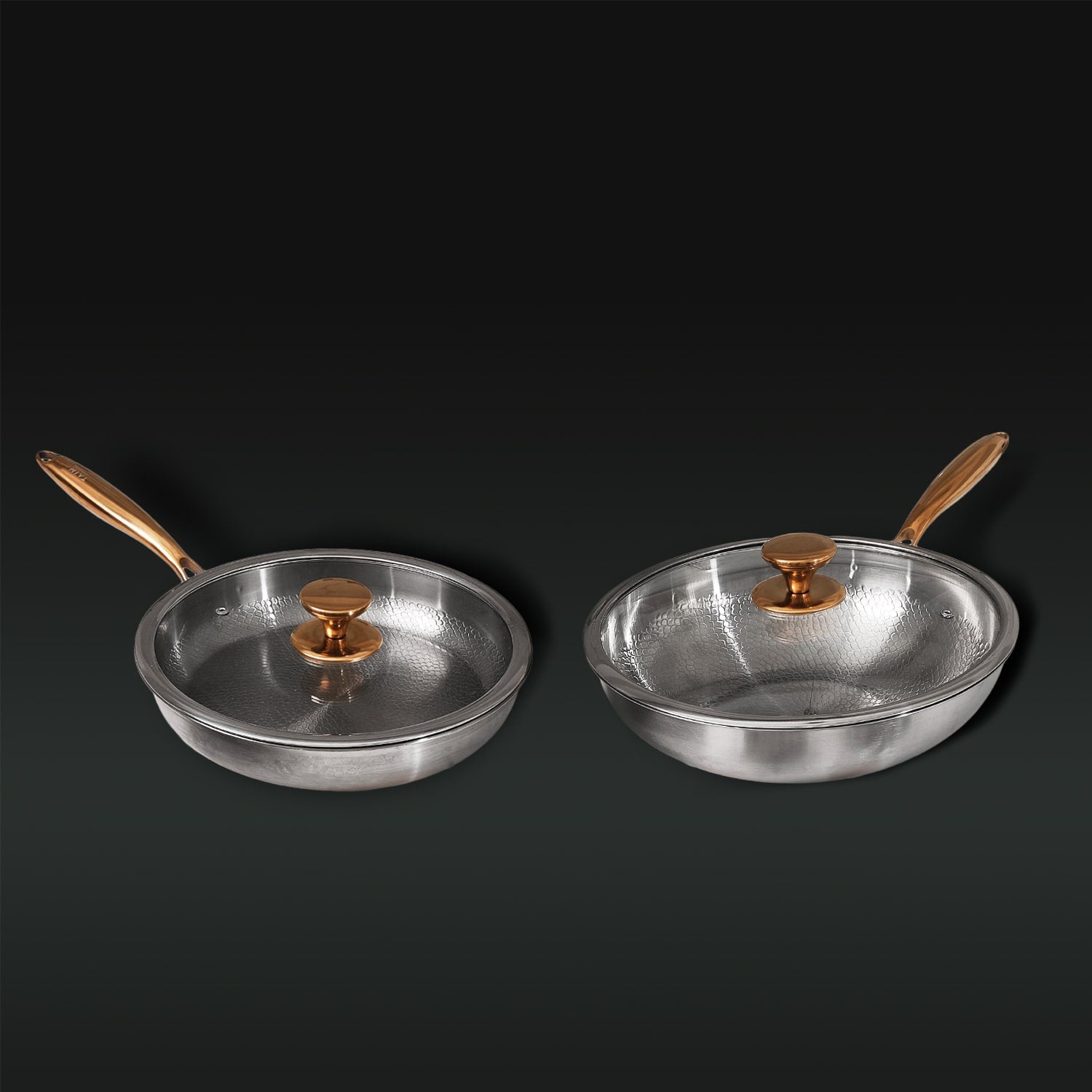 Two Titanium frying pans with gold handles and lids