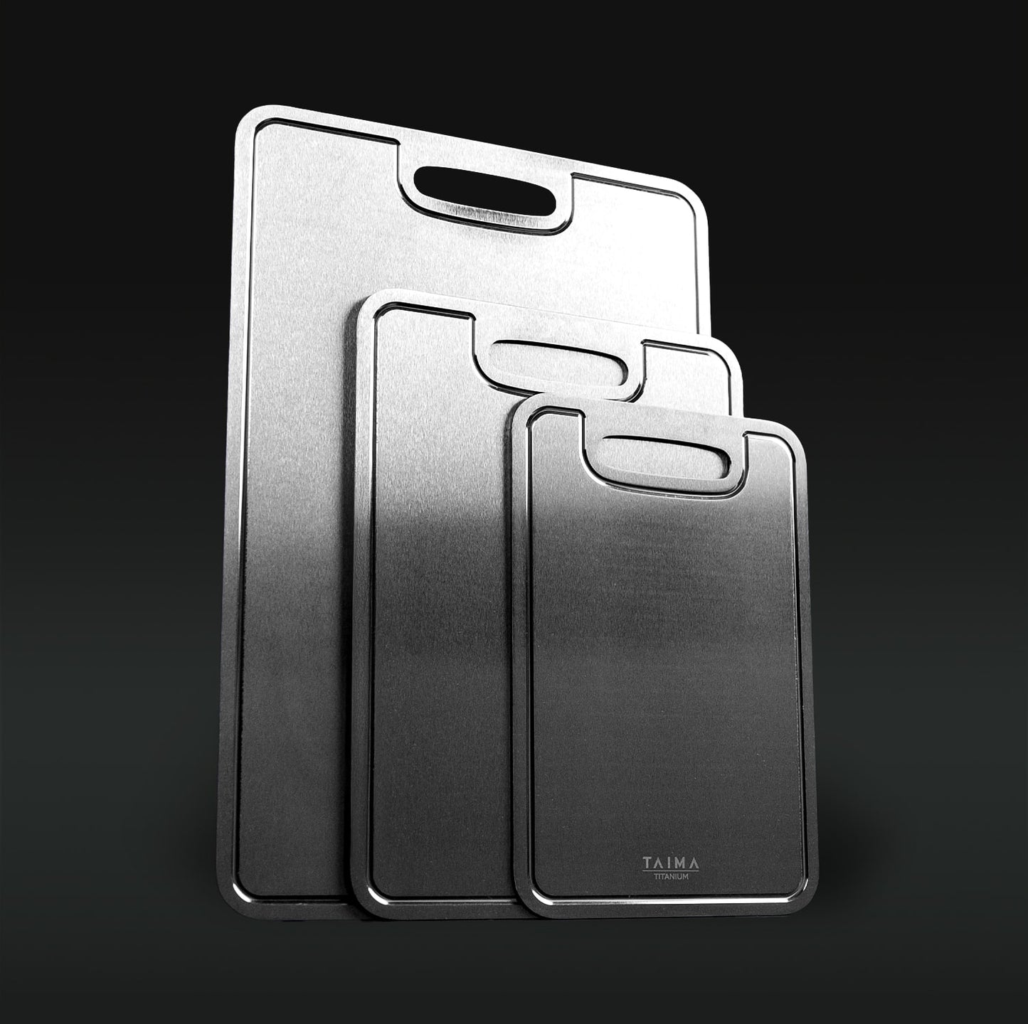 Three Titanium cutting boards with handles