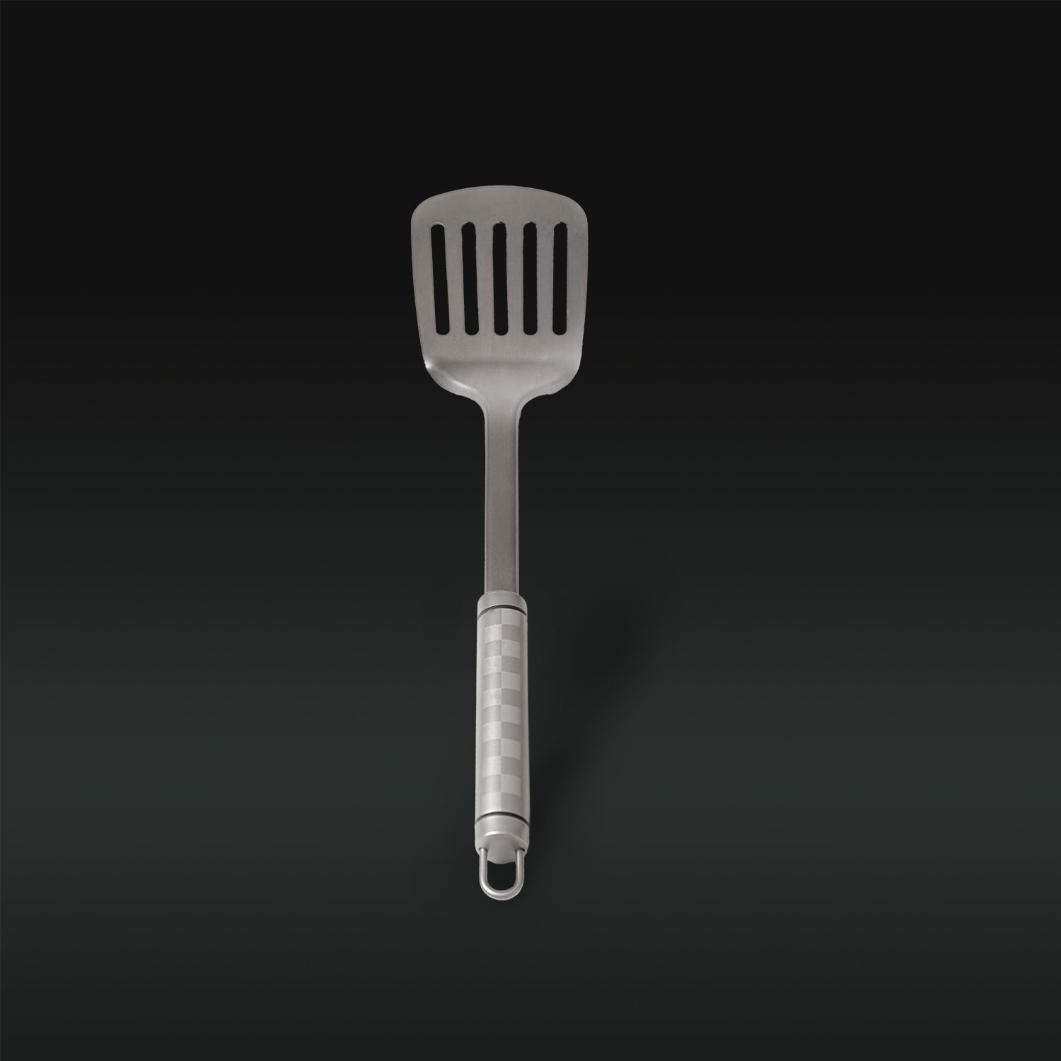 Metallic slotted spatula on a black background