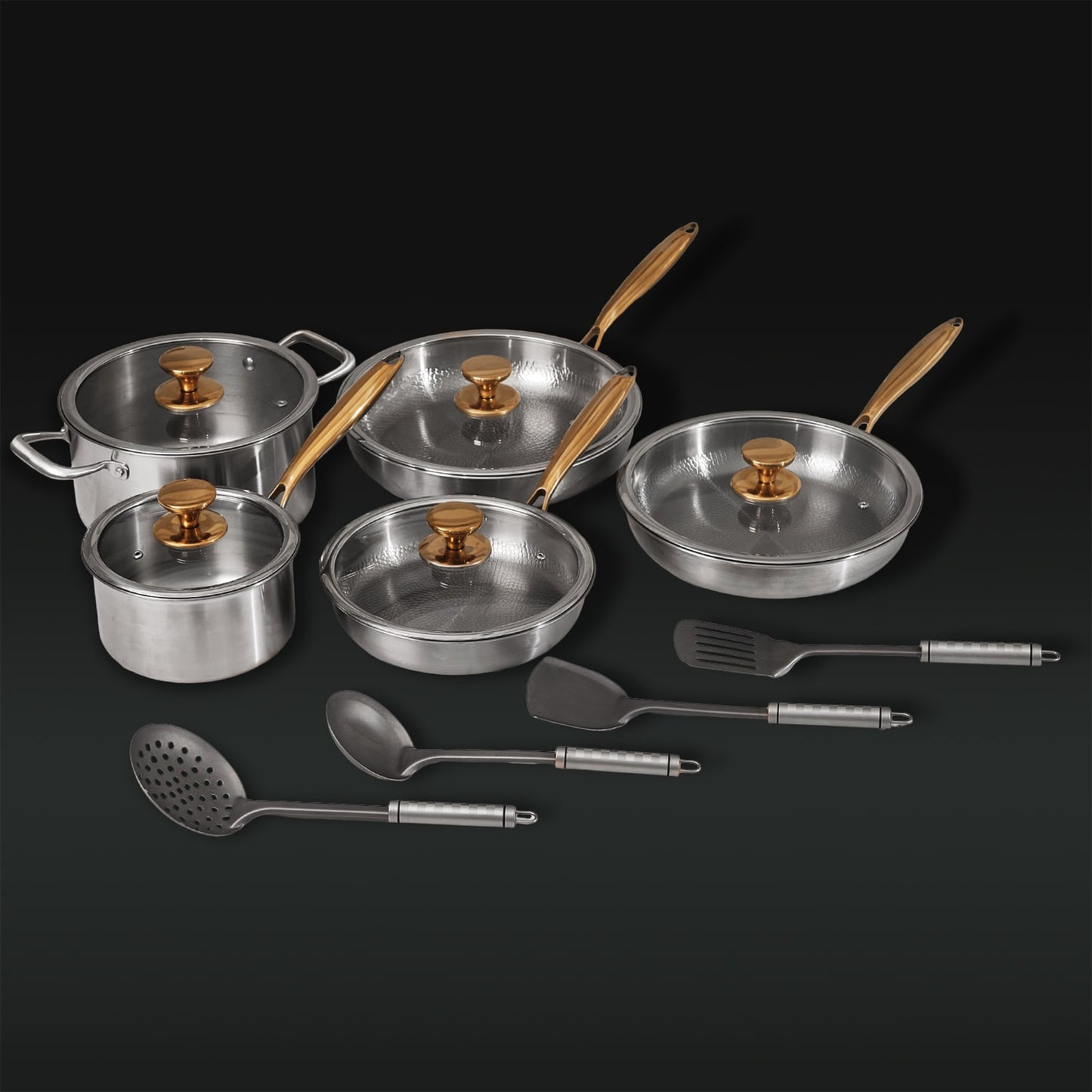 Set of stainless steel cookware with lids and utensils