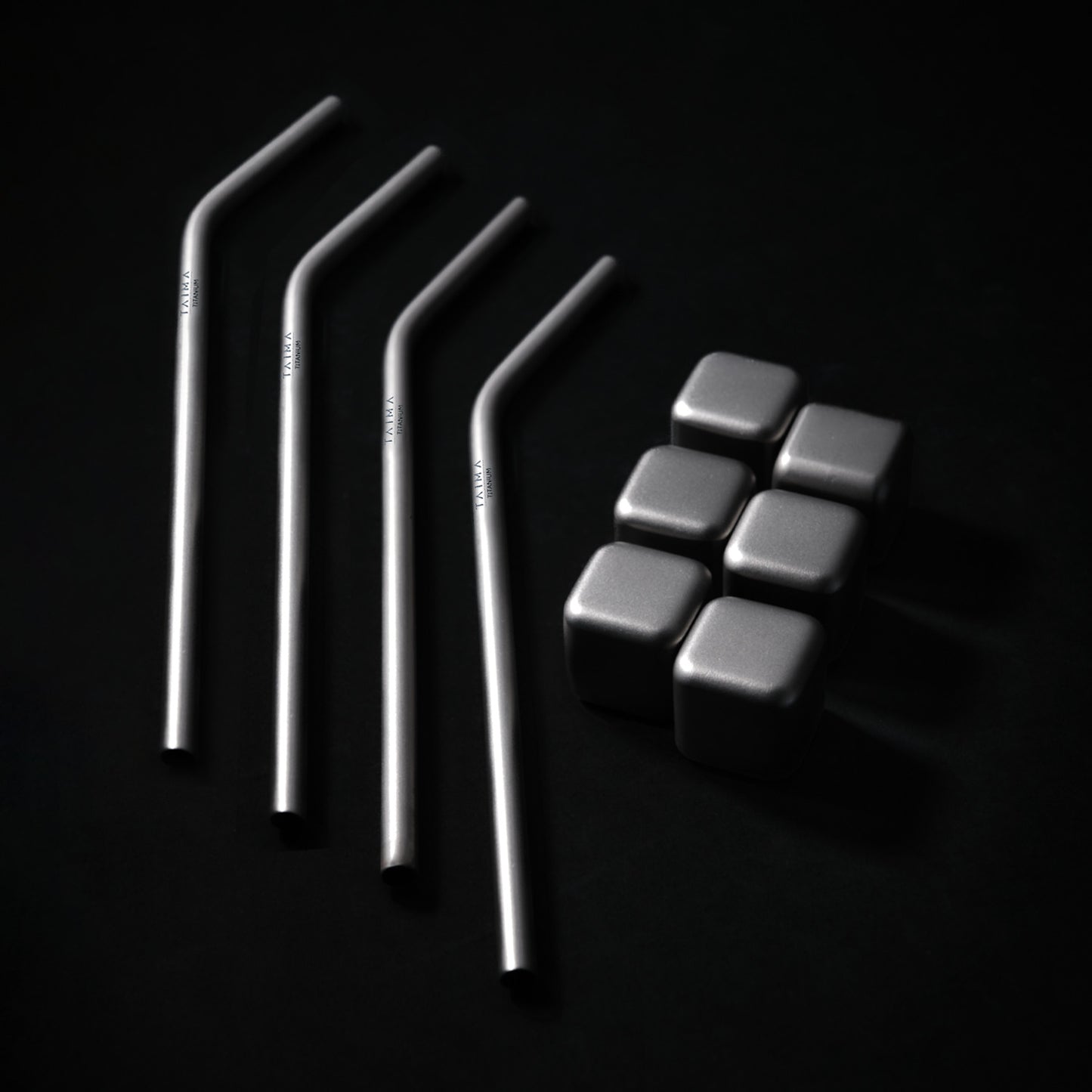 Set of metal straws and metal cubes