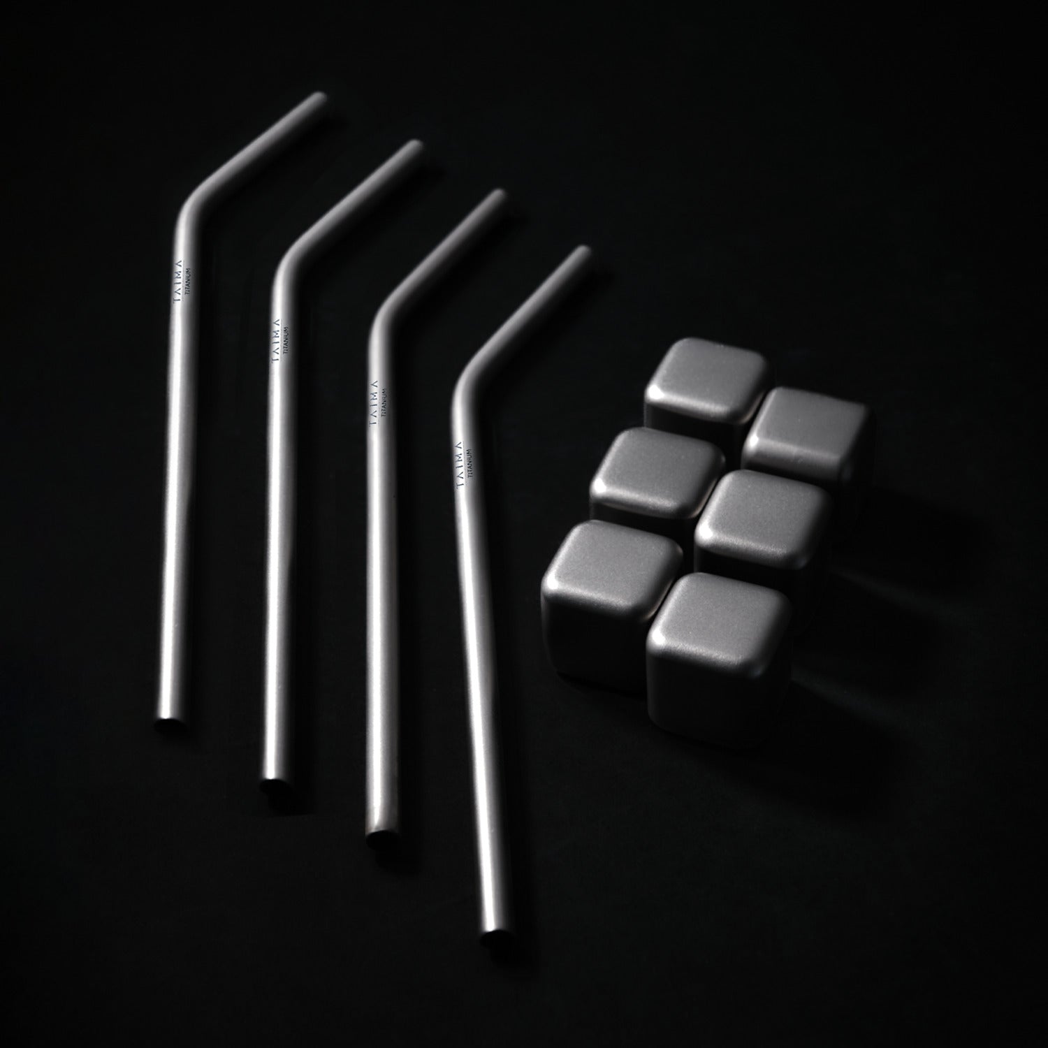 Set of metal straws and metal cubes
