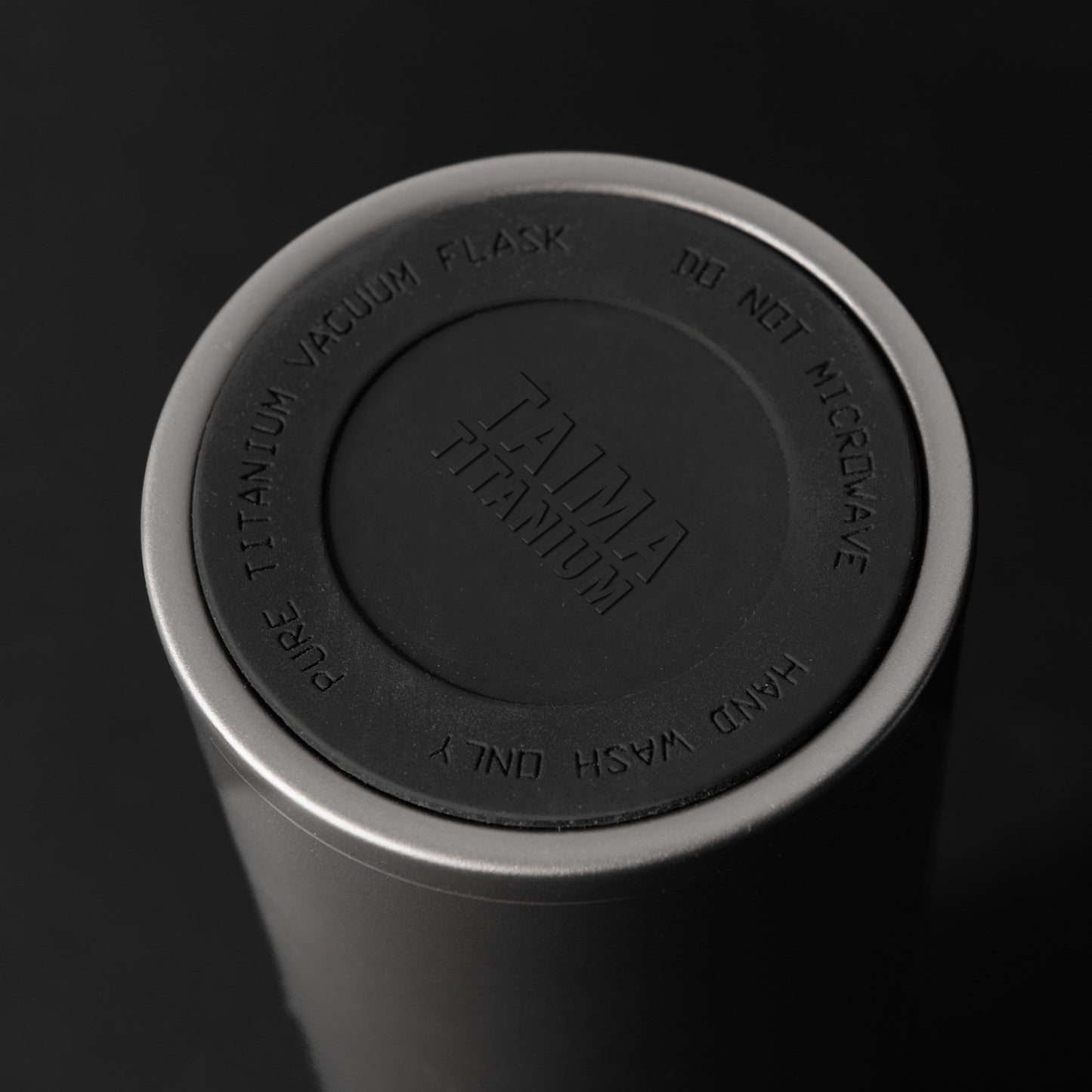 Tumbler with Titanium Vacuum Flask lid on a black background