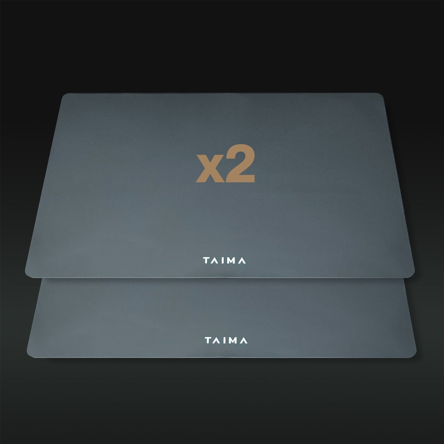 Two gray placemats with 'x2' and 'TAIMA' branding on a dark background