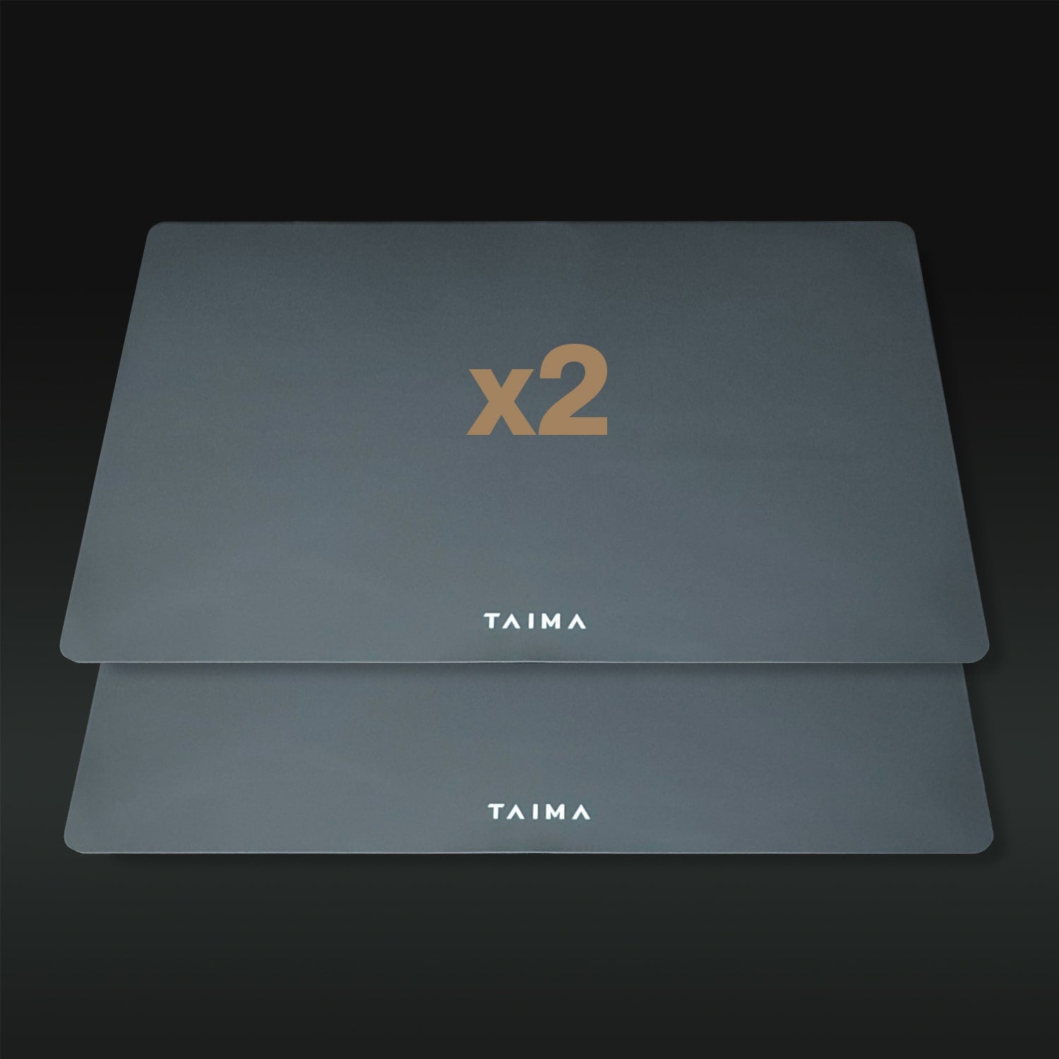 Two gray placemats with 'x2' and 'TAIMA' branding on a dark background